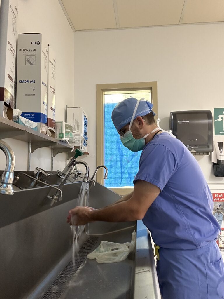 Photo of a doctor performing a surgical scrub. 