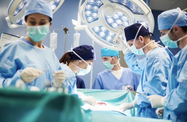 Photo of surgical attendings and resident doctors in a surgical setting. 