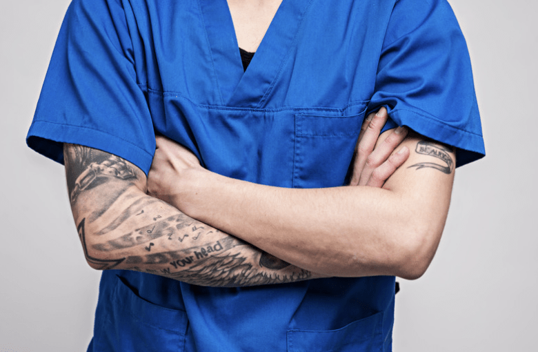 Photo of a doctor with arm tattoos